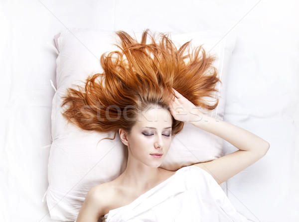Fashion red-haired girl in the bedroom. Stock photo © Massonforstock