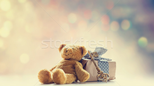 cute teddy bear, golden key and beautiful gift on the fairy ligh Stock photo © Massonforstock