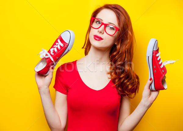 photo of beautiful young woman with red gumshoes on the wonderfu Stock photo © Massonforstock