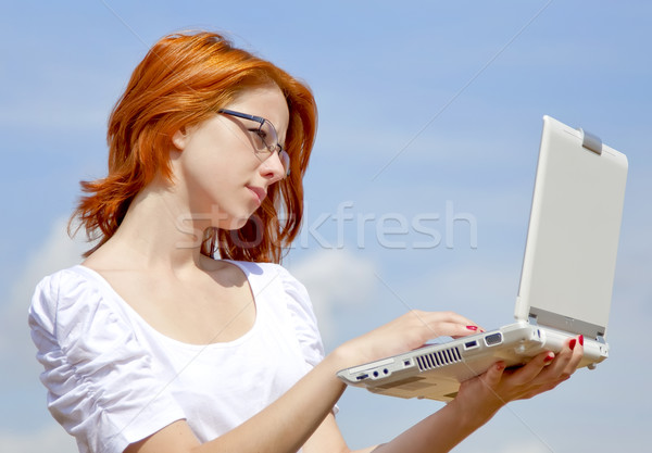 Young Businesswomen in white keeping laptop Stock photo © Massonforstock