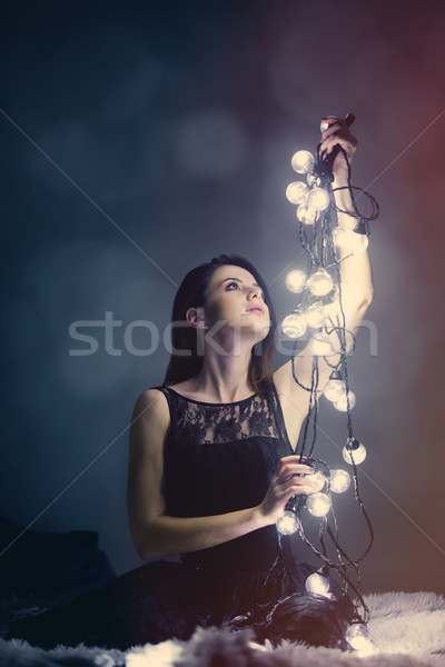 Fiatal nő tündér fények portré bent fény Stock fotó © Massonforstock