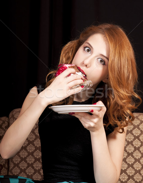 Redhead girl secretly eating cake. Stock photo © Massonforstock