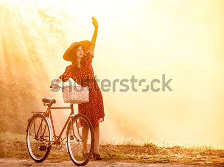 Girl on a bike in the countryside in sunrise time Stock photo © Massonforstock