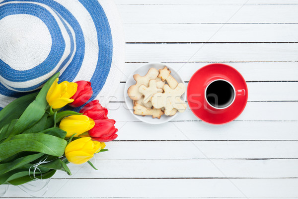 Cup of coffee with hat and tulips  Stock photo © Massonforstock