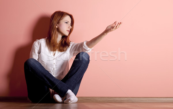 Sad teen girl at floor near wall.  Stock photo © Massonforstock