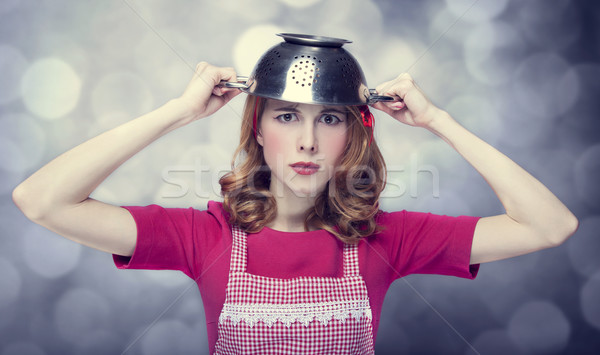 Redhead housewife with colander over head Stock photo © Massonforstock