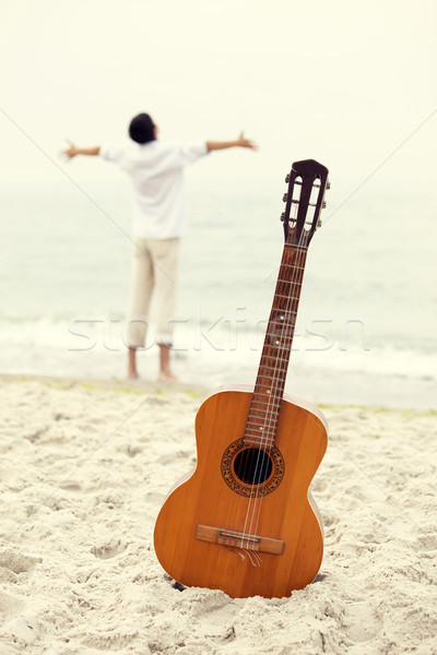 Stock photo: Men at the beach and guitar.