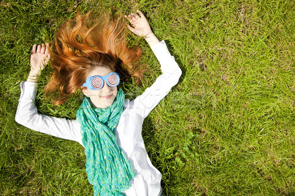 Dziewczyna leży zielona trawa parku wiosną trawy Zdjęcia stock © Massonforstock