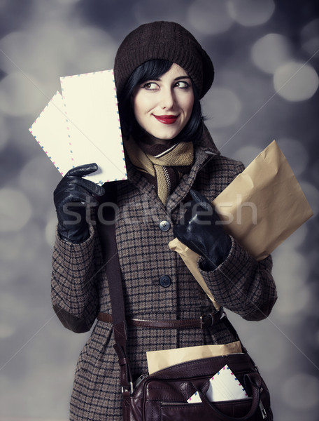 Young postman girl with mail. Photo in old color style with boke Stock photo © Massonforstock