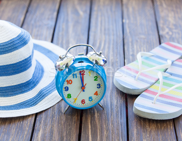 Alarm clock and hat with flip flops  Stock photo © Massonforstock