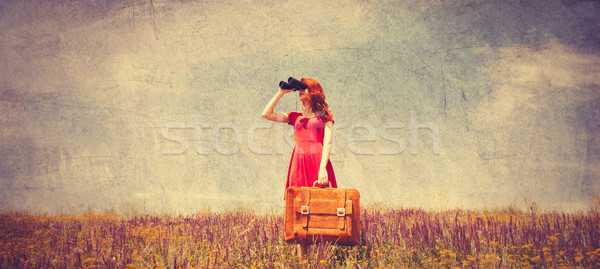 girl in red dress with suitcase and binocular Stock photo © Massonforstock