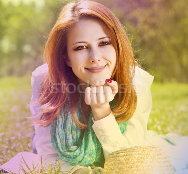 Redhead girl at grass in the park. Photo in multicolor style. Stock photo © Massonforstock