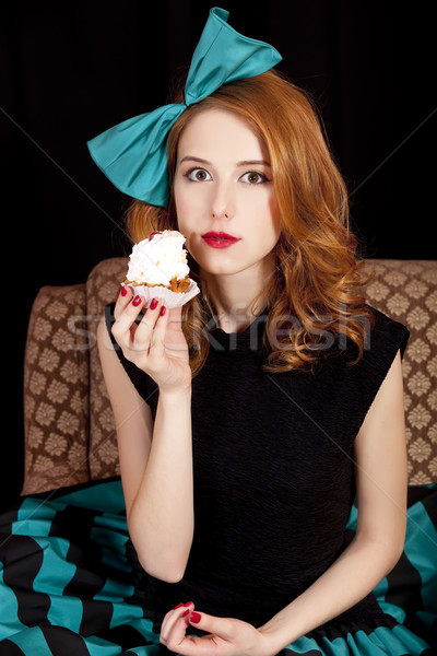 Redhead girl secretly eating cake. Stock photo © Massonforstock