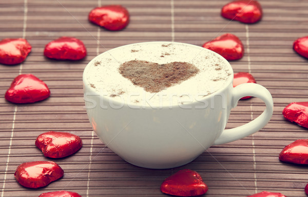 Cup of coffee with heart symbol and candy around. Stock photo © Massonforstock