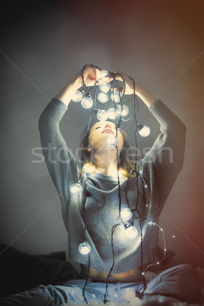 young woman with fairy lights Stock photo © Massonforstock