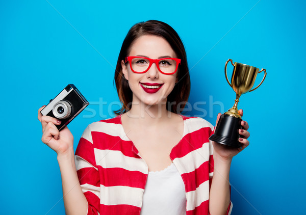woman with cup trophy and retro camera  Stock photo © Massonforstock