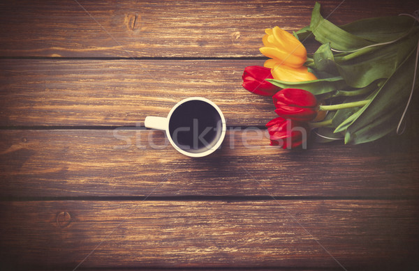 Cup of coffee and tulips on wooden table.  Stock photo © Massonforstock