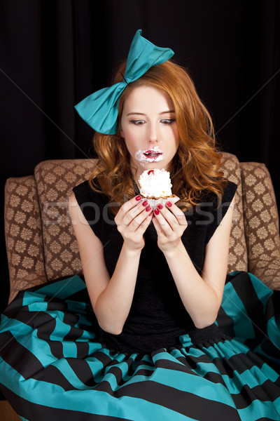 Redhead girl secretly eating cake. Stock photo © Massonforstock