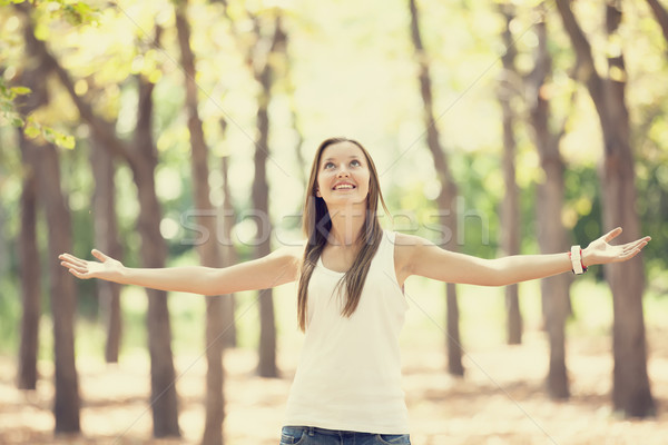 Smiling happy girl in autumn park Stock photo © Massonforstock