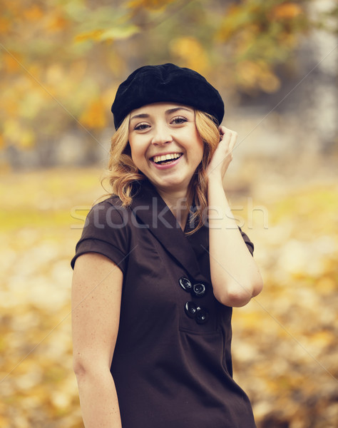 Redhead girl in the autumn park. Stock photo © Massonforstock