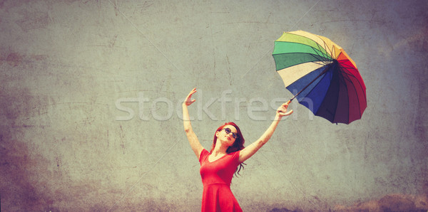 girl in red dress with umbrella Stock photo © Massonforstock