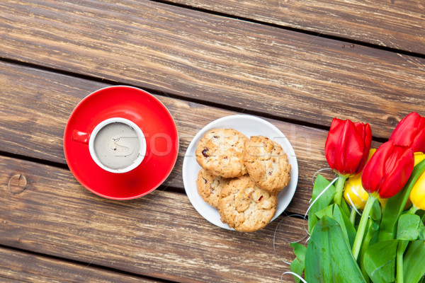 bunch of tulips, plate full of cookies and cup of coffee on the  Stock photo © Massonforstock