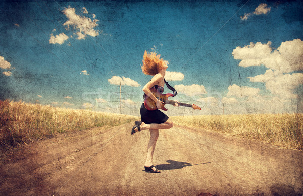 Red-head girl with guitar. Photo in old image style. Stock photo © Massonforstock
