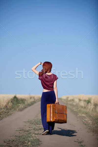 Ragazza valigia campagna strada campo di grano Foto d'archivio © Massonforstock