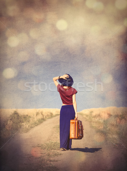 beautiful young woman with suitcase standing in the middle of th Stock photo © Massonforstock