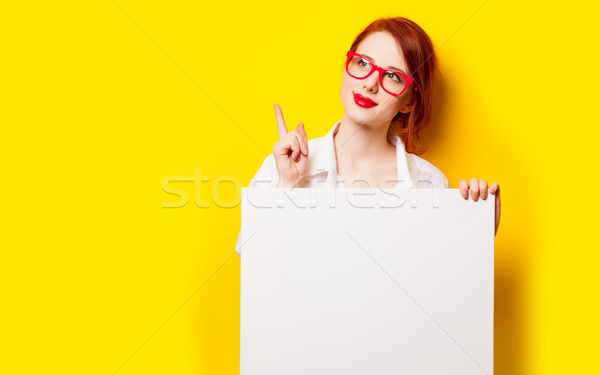 photo of beautiful young woman holding empty poster on the wonde Stock photo © Massonforstock