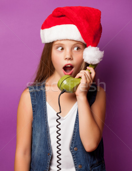 girl in red Santas hat with green handset  Stock photo © Massonforstock