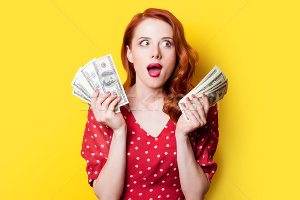 Stock photo: girl in red dress with money