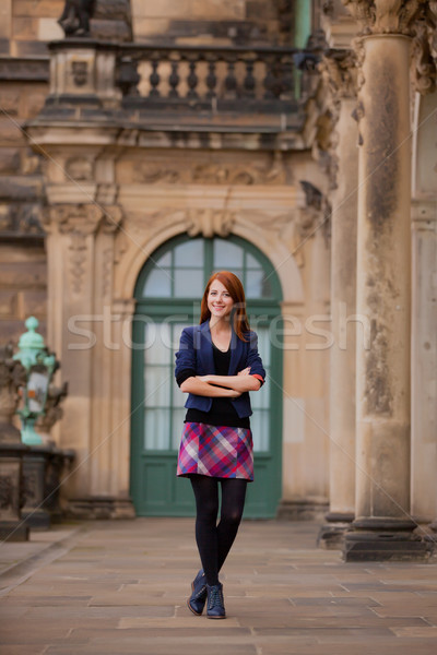beautiful young woman standing in front of old building Stock photo © Massonforstock