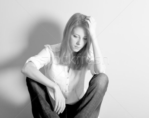 Sad teen girl at floor near wall. Photo in black and white style Stock photo © Massonforstock