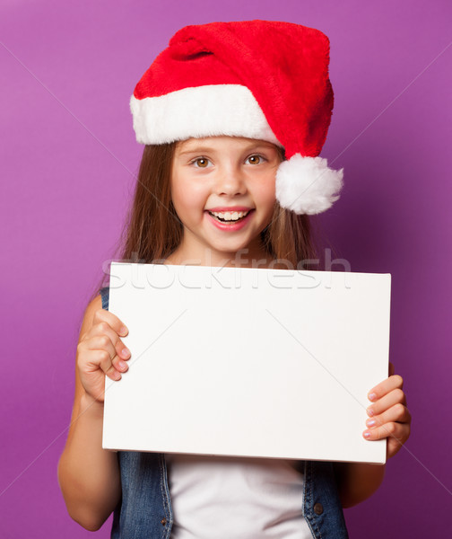 girl in red Santas hat with white board Stock photo © Massonforstock