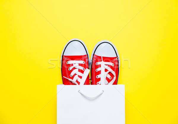 big red gumshoes in cool shopping bag on the wonderful yellow ba Stock photo © Massonforstock