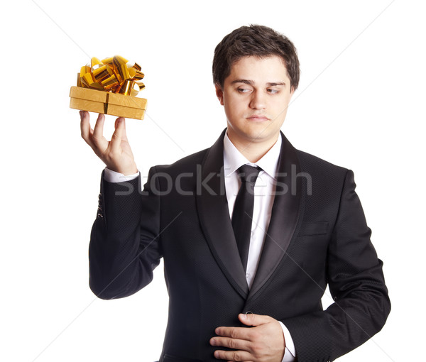 A man holding present box in formal black tux Stock photo © Massonforstock