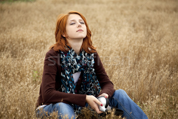 Lonely sad red-haired girl at field Stock photo © Massonforstock