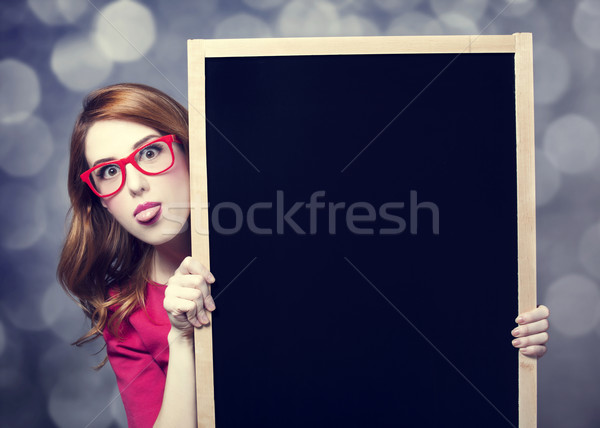 Redhead student with blackboard. Stock photo © Massonforstock