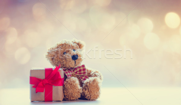 cute teddy bear and beautiful gift on the fairy lights bokeh bac Stock photo © Massonforstock