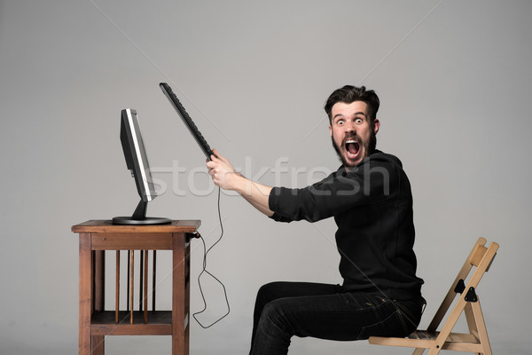 Angry man is destroying a keyboard Stock photo © master1305