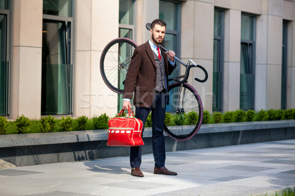 Handsome businessman carrying his bicycle in office Stock photo © master1305