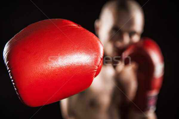 The young man kickboxing on black Stock photo © master1305