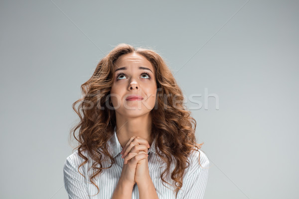 Woman is looking imploring over gray background Stock photo © master1305