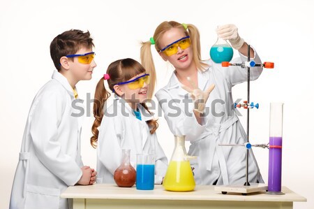 Teens and teacher of chemistry at  lesson making experiments Stock photo © master1305