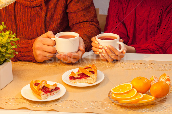 Stock photo: The  happy young couple with cups of tea 