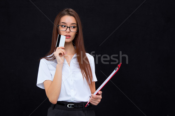 The young business woman with credit card and tablet for notes on gray background Stock photo © master1305