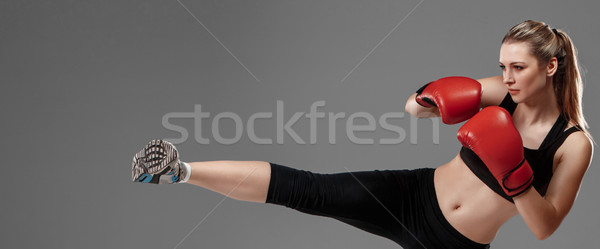 beautiful woman is boxing on gray background Stock photo © master1305