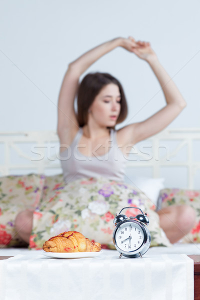 The young girl in bed with  clock service Stock photo © master1305