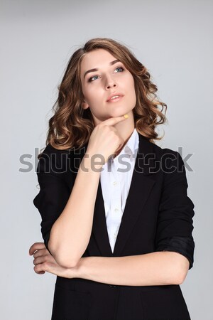 The happy thoughtful woman on gray background Stock photo © master1305
